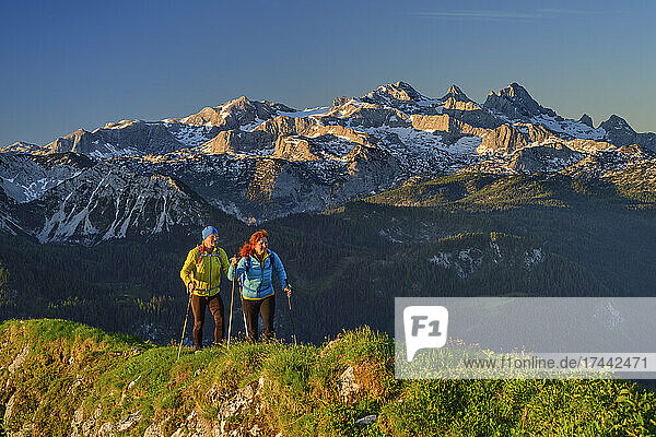Männliche und weibliche Freunde wandern im Urlaub in den Chiemgauer Alpen