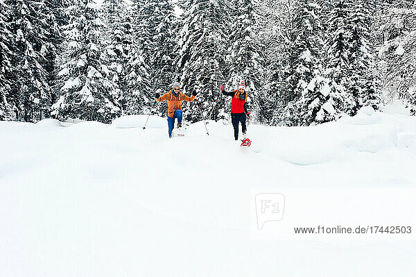 Man and woman snowshoeing during winter