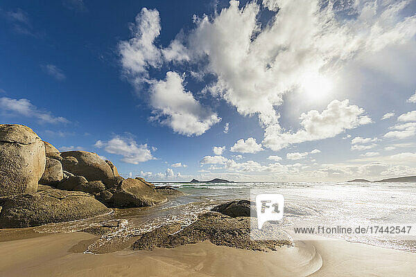 Sun shining over sandy coastal beach of Indian Ocean  Australia