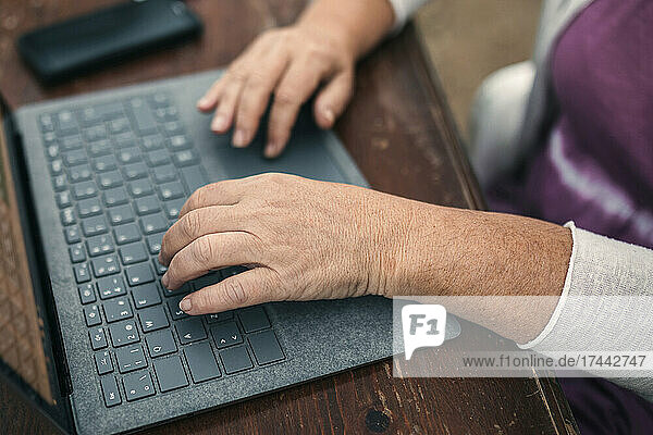 Woman using laptop while working at table