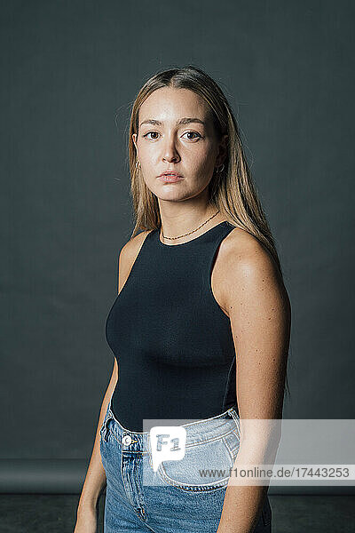 Confident young woman in studio