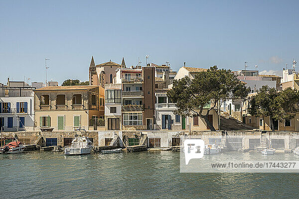 Spain  Balearic Islands  Porto Colom  Boats moored in front of waterfront houses