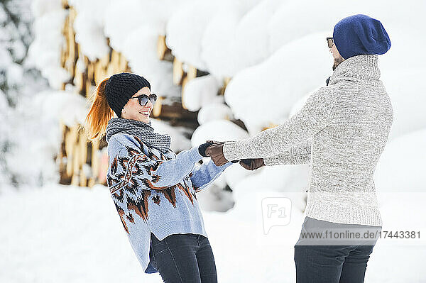 Woman holding man's hands during winter