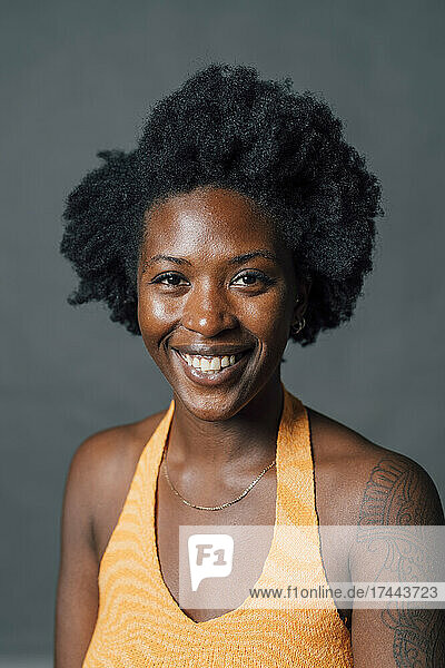 Happy Afro young woman in studio