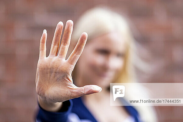 Frau zeigt Stoppschild mit der Handfläche
