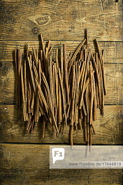 Cinnamon sticks lying on wooden surface