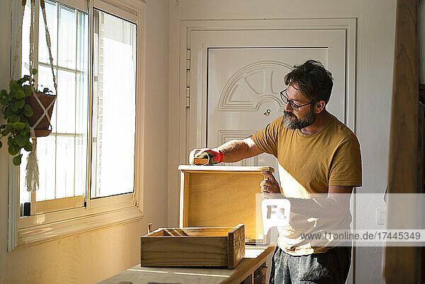 Mature male carpenter working at home