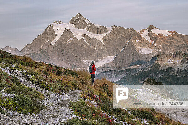 Female Hiker Standing In Front Of Mount Shuksan In The Cascades