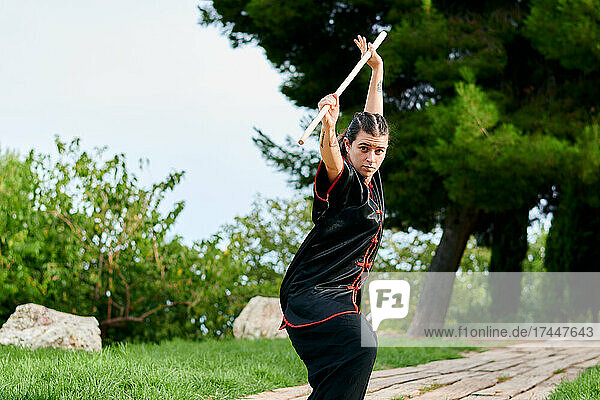Woman practice kung fu with a stick