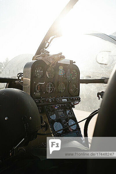 Inside cockpit of a military helicopter with sunlight