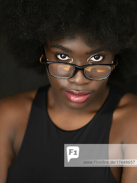 Beautiful young black woman with afro hair  wearing glasses