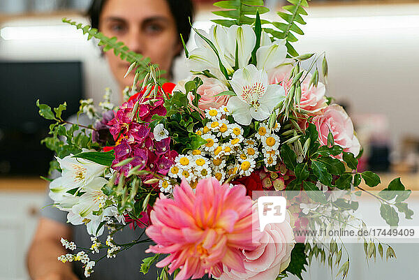 Unrecognizable florist preparing a bunch of flowers