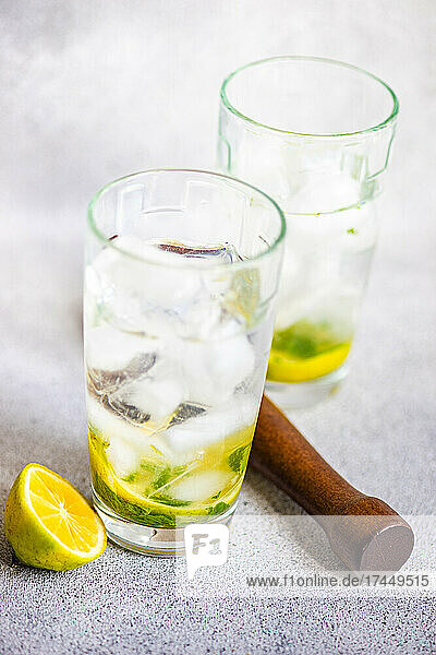 Lemon water with ice and mint in glass
