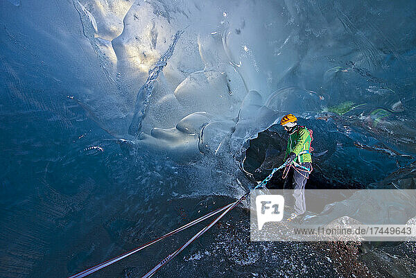 Woman exploring icecave on Svinafellsjokull glacier