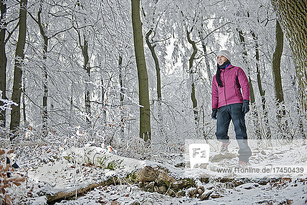 woman hiking through frosty German forest in Lower Saxony