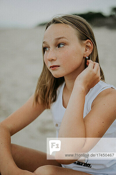 portrait of teenage girl sitting on the beach