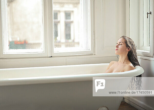 young woman in a vintage bathtub