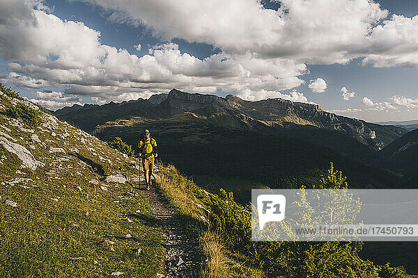 Man hiking with a backpack against clouds  Pyrenees  Spain