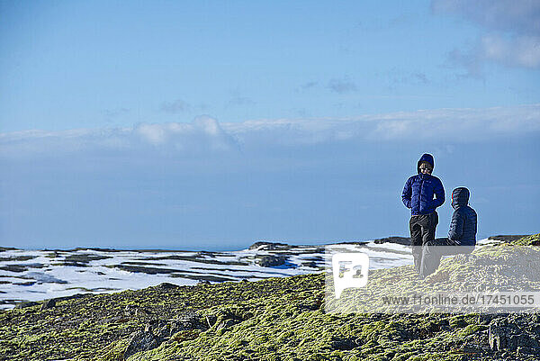 couple at the edge of the Myrdlasjokull glacier in south Iceland