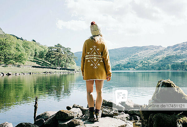 woman stood enjoying a lake and mountain view in Wales  UK