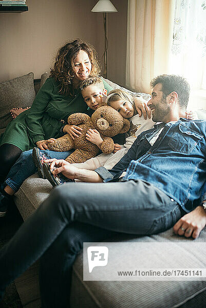 Happy family with teddy bear toy.