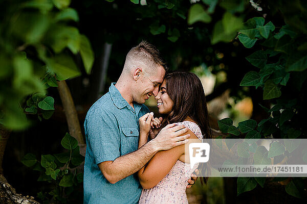 Husband & Wife Posing Under Tree in San Diego