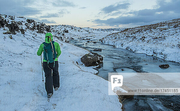 woman hiking through the frozen landscape in the west of Iceland