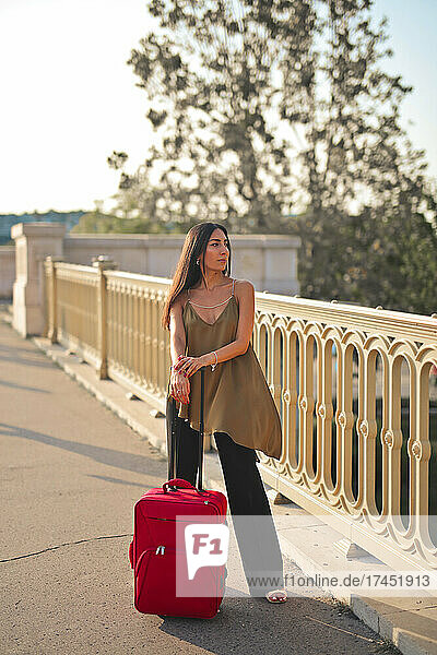 young elegant woman with trolley in the city