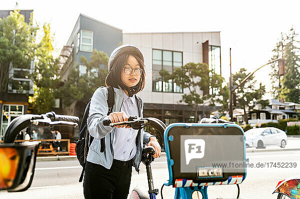 Young professional using bike share in urban setting