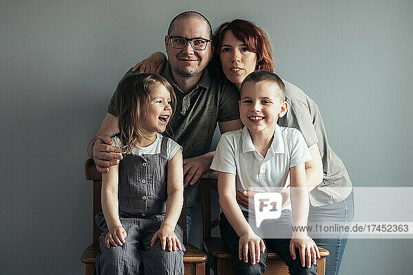 Portrait of happy family on the grey background at home.