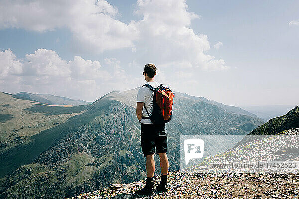 man enjoying the view at the summit of Mount Snowdon Wales