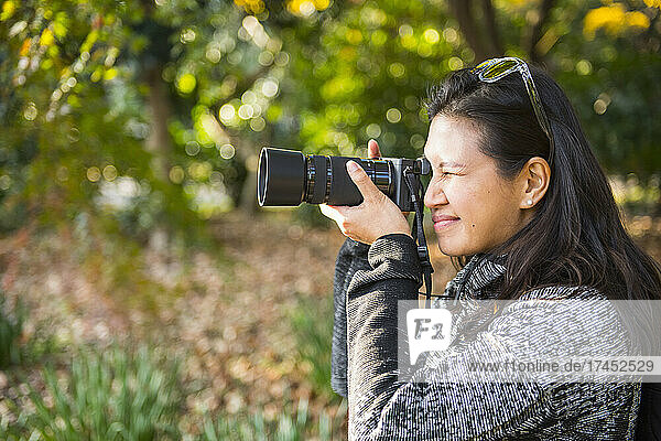 woman taking a picture with digital mirrorless camera