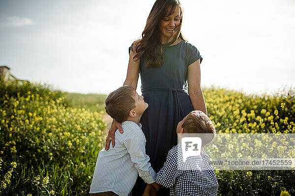 Mother Standing with Sons in Wildflower Field