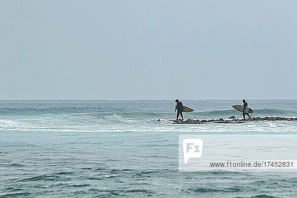 Surfers in Indian Ocean  Maldives