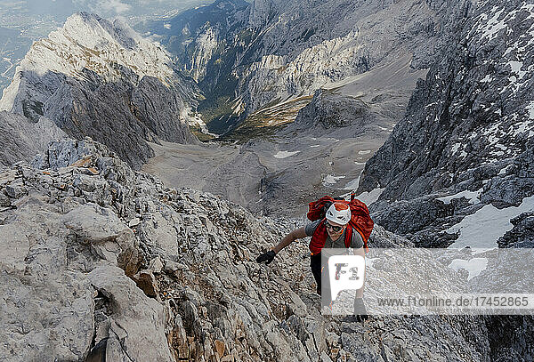 Man climbing steep rock mountain
