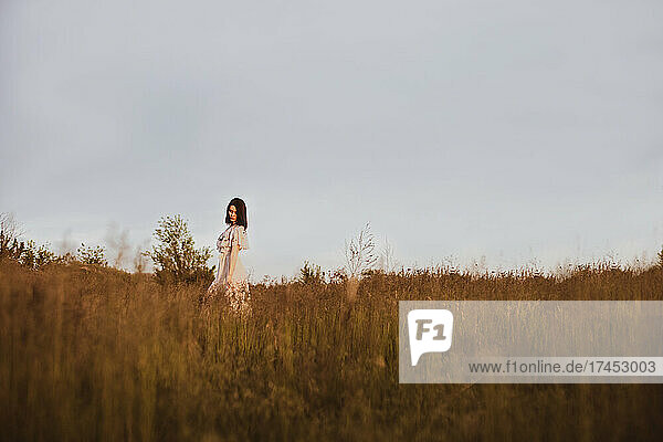 Girl walk in grass summer countryside field