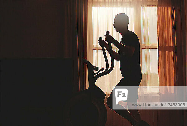 A man goes in for sports at dawn at home  silhouette