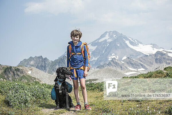 A boy and his dog hiking in Glacier Peak Wilderness.
