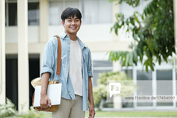 Young male student at university campus.