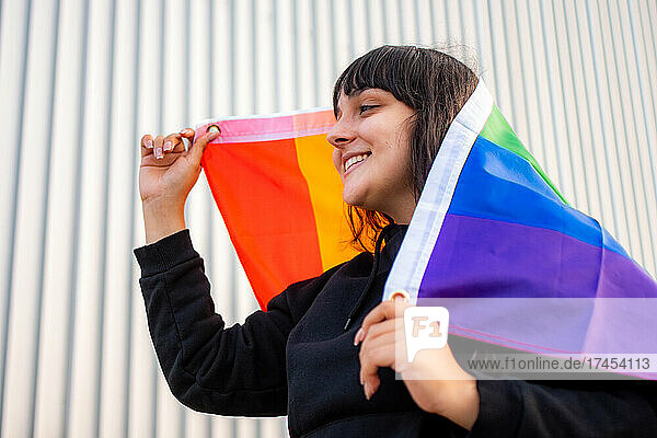 Portrait of a latina woman wearing the rainbow flag