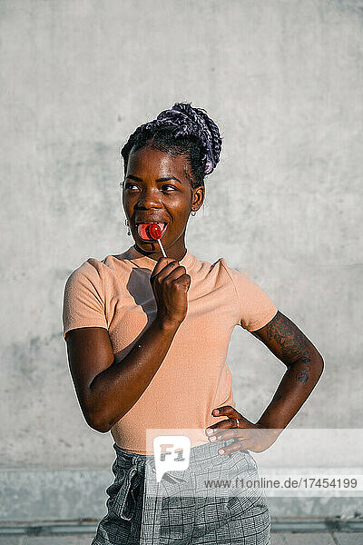 black woman posing proud with a lollipop