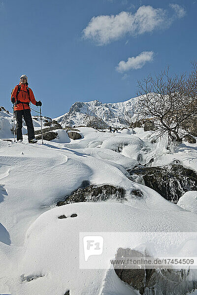 Woman descending through snow and ice from Mount Tryfan