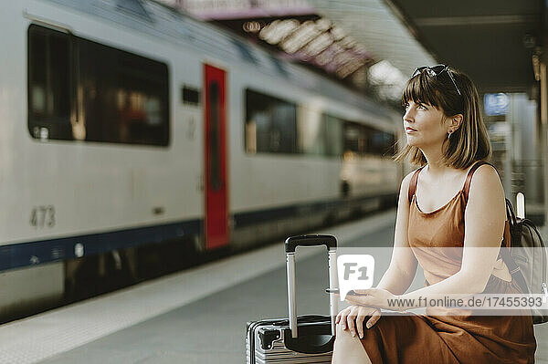 Tourist woman sitting in Antwerp train station