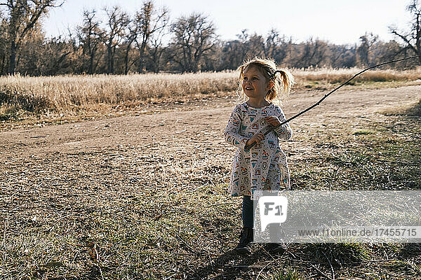 Smiling girl with stick in her hand  Colorado