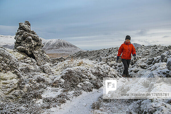 woman hiking through frozen landscape in Iceland