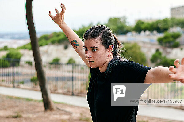 Woman trains kung fu in a park
