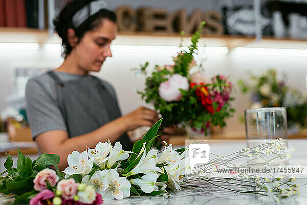Florist preparing a bunch of flowers for a client