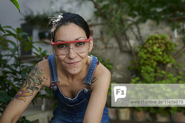 A smiling young woman with safety goggles looking at the camera.