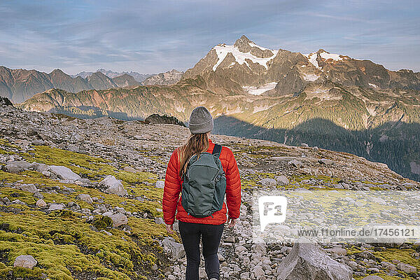 Female In Tights Standing In Front Of Mount Shuksan In The Cascades