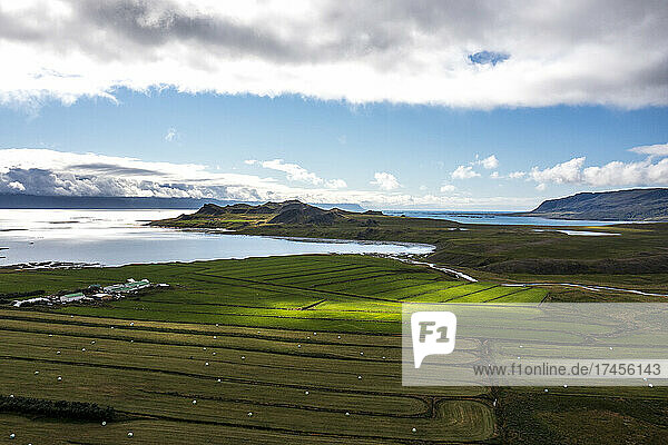Sun hits a grass field on farmland in west Iceland.